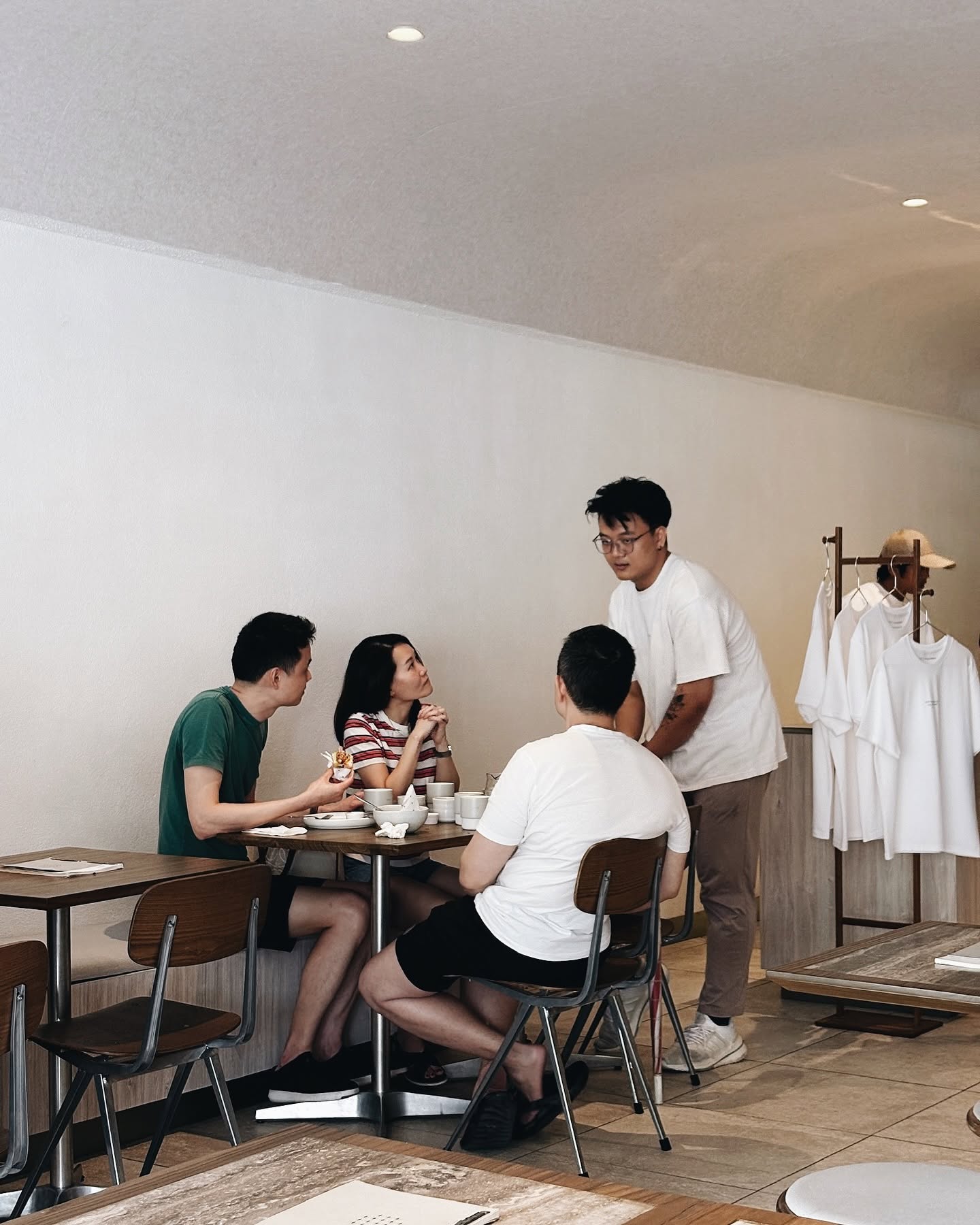 Inside Story of Ono — warm-minimal café in SS2 with wood furniture, greige walls, natural light and guests dining
